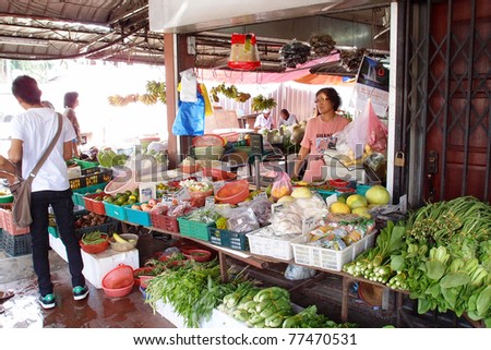 KUCHING - MAY 13: An unidentified lady waits for buyers at her vegetable shop, May 13, 2011 in Kuching, Borneo Island. Most of the shops cater to the town-folks and a growing number of tourists.
