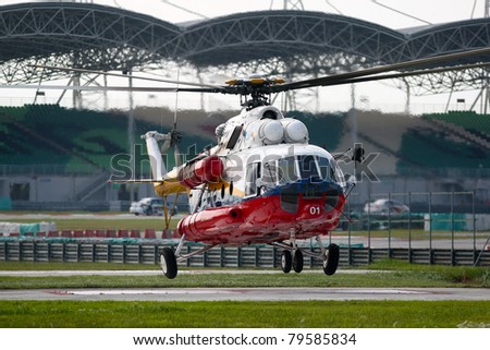 SEPANG - JUNE 17: A rescue helicopter from the Fire Department flies in on standby evacuation in the Sepang International Circuit during the GT Asia Series race on June 17, 2011 in Sepang, Malaysia.