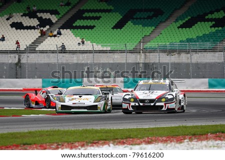 SEPANG - JUNE 19: Cars take turn one of the Sepang International Circuit in a tight pack at the Japan SUPER GT Round 3 race on June 19, 2011 in Sepang, Malaysia.