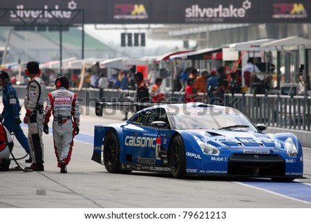 SEPANG - JUNE 19: Team Impul\'s Nissan GTR car leaves the pit-lane after tire change at the practice round of the Japan SUPER GT Round 3 race on June 19, 2011 in Sepang international Circuit, Malaysia.