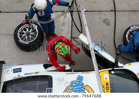 SEPANG, MALAYSIA - JUNE 19: LMP Motorsport\'s makes a driver change and tires change during pit-stop at the Sepang International Circuit at the Japan SUPER GT Round 3 race on June 19, 2011 in Sepang, Malaysia.