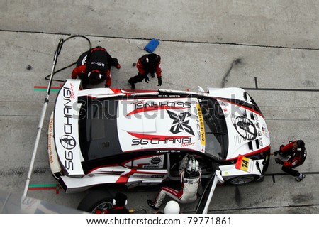 SEPANG, MALAYSIA - JUNE 19: Team SG Changi car pits for refuel, and driver and tire change at the Sepang International Circuit in the Japan SUPER GT Round 3 race on June 19, 2011 in Sepang, Malaysia.
