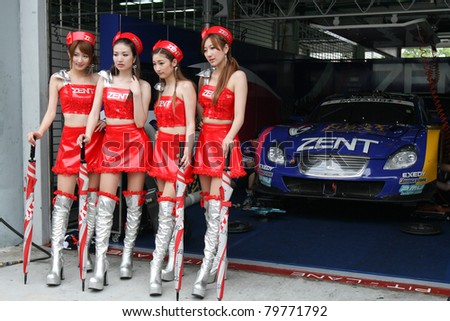 SEPANG - JUNE 19: Race queens from the team of \'Lexus Team Zent Cerumo\' pose with the team car at the Sepang International Circuit at the Japan SUPER GT Round 3  on June 19, 2011 in Sepang, Malaysia.