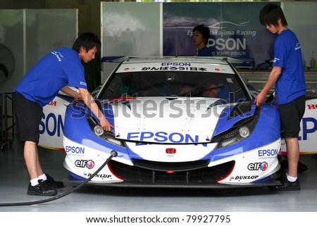 SEPANG - JUNE 18: The Nakajima Racing crew prepares the Honda HSV-010 car for the practice session of the Japan SUPER GT event at the Sepang International Circuit on June 18, 2011 in Sepang, Malaysia.