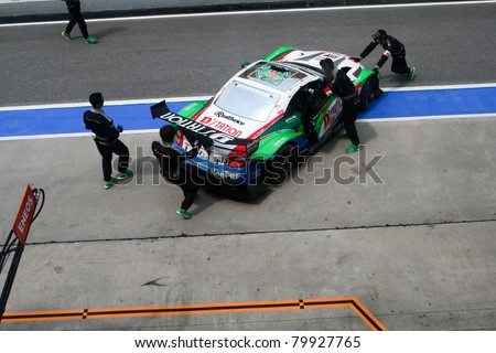 SEPANG, MALAYSIA - JUNE 18: The mechanics push back the Lexus Team Kraft's car into the garage in the Sepang International Circuit at the Japan SUPER GT Round 3 on June 18, 2011 in Sepang, Malaysia.