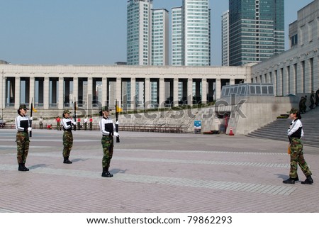 SEOUL - JUNE 08: Female soldiers from the army perform a gun drill at the Korean War Memorial Museum on June 08, 2011 in Seoul, South Korea. South Korea is still technically at war with North Korea.