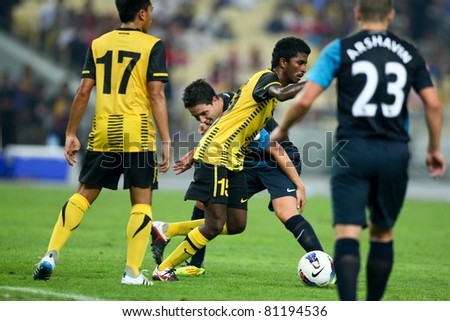 BUKIT JALIL - JULY 13: K. Gurusamy (15) dribbles past Arsenal's Samir Nasri in a friendly match on July 13, 2011 in Stadium Bukit Jalil, Malaysia. English Premier League team Arsenal beat Malaysia 4-0