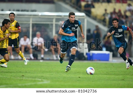 BUKIT JALIL - JULY 13: Arsenal\'s Robin van Piersie sees action in the second half against Malaysia on July 13, 2011 in Stadium Bukit Jalil, Malaysia. English league team Arsenal is on an Asia Tour.