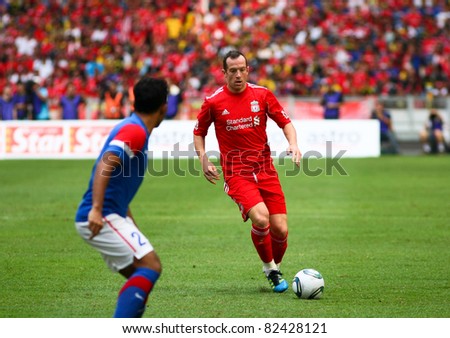 BUKIT JALIL, MALAYSIA - JULY 16: Liverpool's Charlie Adam (red) dribbles the ball in the game against Malaysia at the National Stadium on July 16, 2011, Bukit Jalil, Malaysia. Liverpool won 6-3.
