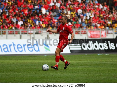 BUKIT JALIL, MALAYSIA - JULY 16 : Liverpool's Joe Cole (red) dribbles with the ball in the game against Malaysia at the National Stadium on July 16, 2011, Bukit Jalil, Malaysia. Liverpool won 6-3.