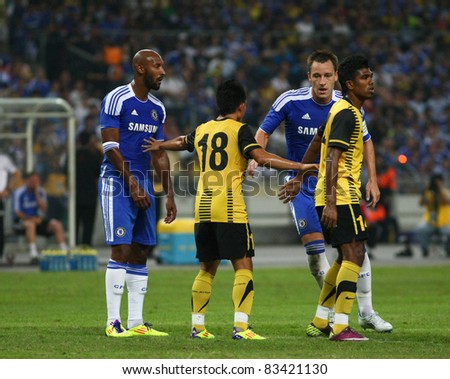 BUKIT JALIL, MALAYSIA - JULY 21: Chelsea's Nicolas Anelka (left, in blue) waits for a free kick in a game against Malaysia at the National Stadium on July 21, 2011 in Bukit Jalil, Malaysia. Chelsea won 1-0.
