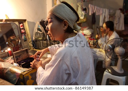 AMPANG, MALAYSIA – OCT 05: Chinese Opera actresses apply makeup at backstage before her show at the Lam Thian Kiong Temple celebrating the ‘Nine Emperor Gods’ Festival on October 05, 2011 in Ampang, Malaysia.