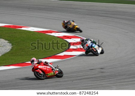 SEPANG, MALAYSIA - OCTOBER 22: Moto2 rider Ivan Moreno (red) leads the other riders at qualifying race of the Shell Advance Malaysian Motorcycle GP 2011 on October 22, 2011 at Sepang, Malaysia.