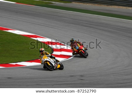 SEPANG, MALAYSIA- OCTOBER 22: Moto2 rider Alex deAngelis (15) races with another rider at the qualifying race of the Shell Advance Malaysian Motorcycle GP 2011 on October 22, 2011 at Sepang, Malaysia.