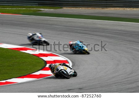 SEPANG, MALAYSIA - OCTOBER 22: Moto2 rider Thomas Luthi (12) races with other riders at the qualifying race of the Shell Advance Malaysian Motorcycle GP 2011 on October 22, 2011 at Sepang, Malaysia.