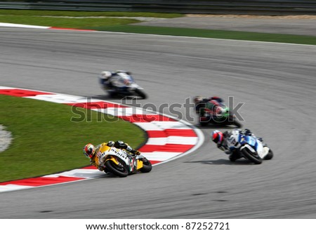 SEPANG, MALAYSIA- OCTOBER 22: Moto2 rider Alex de Angelis (15) races with other riders at the qualifying race of the Shell Advance Malaysian Motorcycle GP 2011 on October 22, 2011 at Sepang, Malaysia.