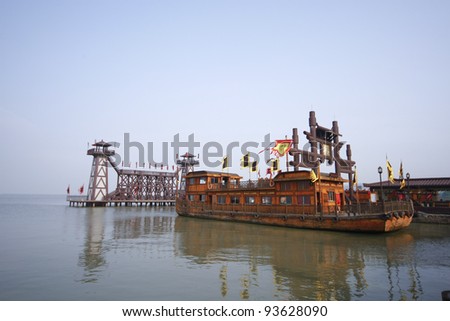 WUXI, CHINA - NOVEMBER 25: An ancient battle ship takes tourists for a cruise at the Tai Lake on Nov 25, 2011 in Wuxi, China. Ships like this took part in the war of the 3 kingdoms in 220AD to 280AD.