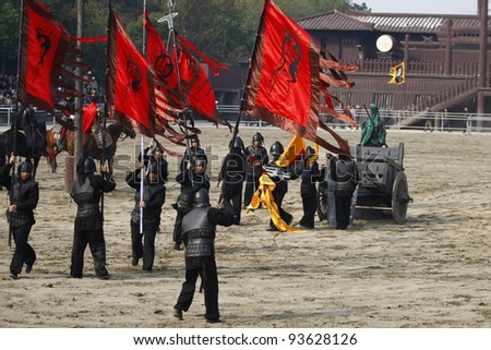 WUXI, CHINA - NOVEMBER 25: Soldiers fight out an ancient war in an outdoor theatre on November 25, 2011 in Wuxi, China.The scene portrays the war of the three kingdoms from 220AD to 280AD in China.