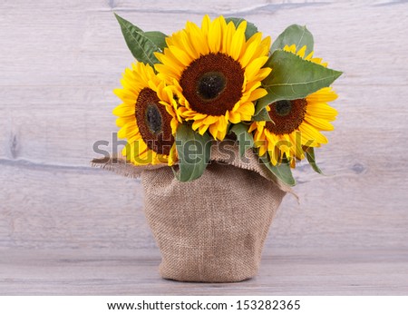 Bouquet of sunflowers on a wooden background.