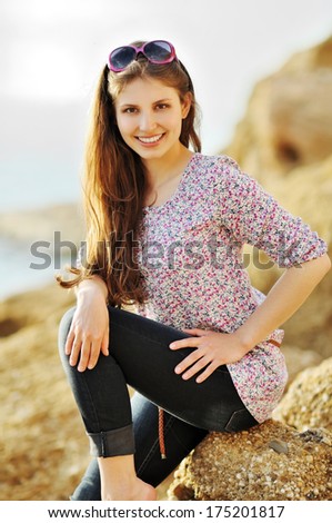 Portrait of the attractive girl on the seashore in country style. Spring theme. Warm colors