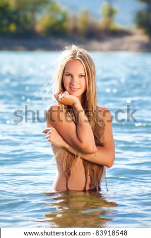 Beautiful naked woman in lake water