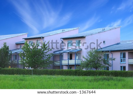 Apartments with garden against a deep blue sky