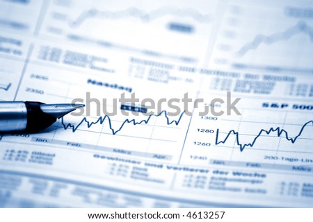 Fountain writing pen on business/finance report (blue tone)