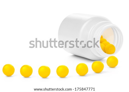 Open plastic medical container with yellow vitamins