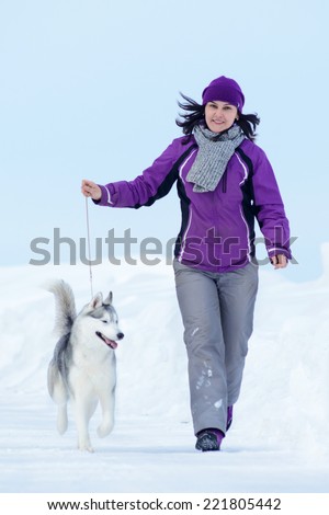 Young woman are walking with siberian husky