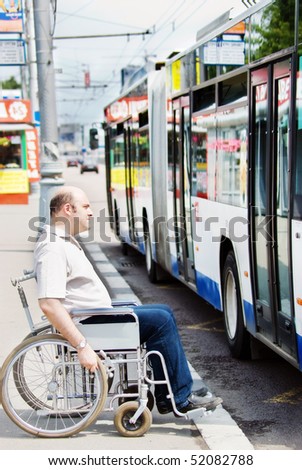 Man in a wheelchair at a bus stop
