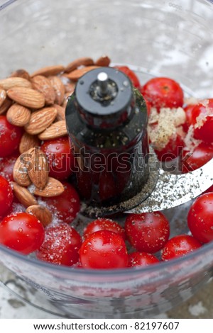 Cherry tomatoes and almonds in a food processor