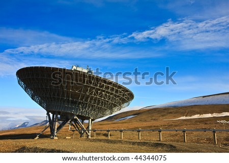 Directional radio antenna on hillside.  Horizontally framed shot.