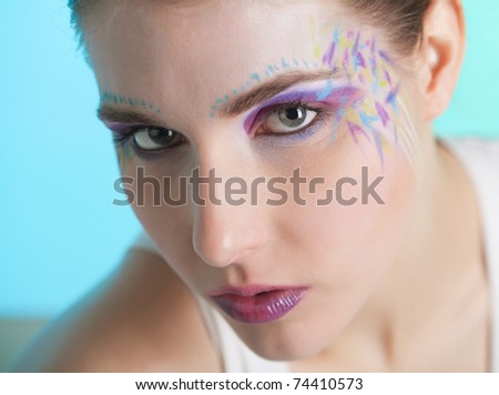 Closeup portrait of a pretty young woman with face art