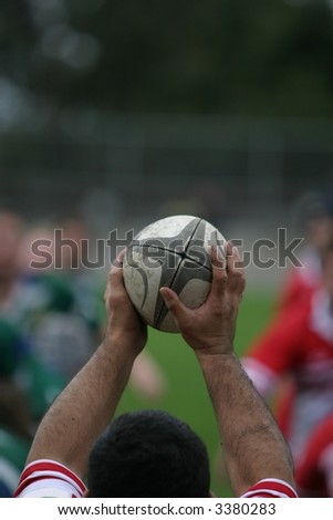 Shot of the hands of the prop, and ball during a rugby lineout.  Shallow DOF