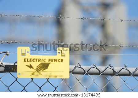 Warning sign on an electric fence on an industrial facility