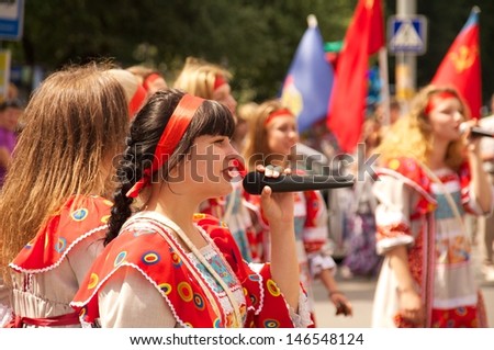 KALININGRAD, RUSSIA - JULY 14: girls in russian national dress sang and danced on the street on City Day of Kaliningrad celebration on July 14, 2013 in Kaliningrad, Russia