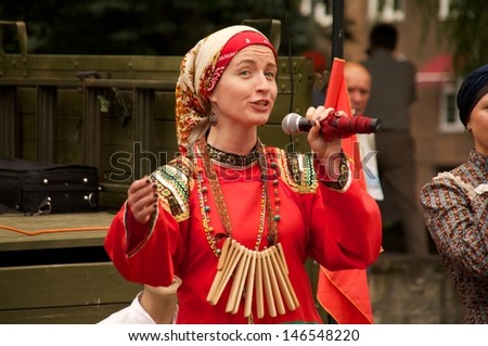 KALININGRAD, RUSSIA - JULY 14: woman in national dress sang and danced on the street on City Day of Kaliningrad celebration on July 14, 2013 in Kaliningrad, Russia