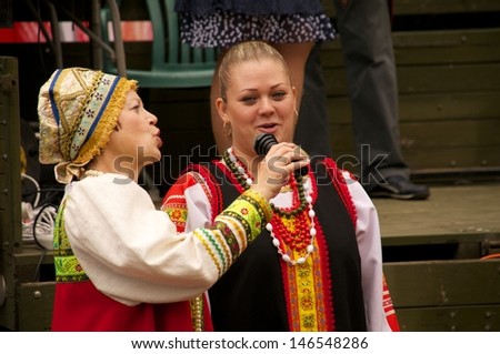 KALININGRAD, RUSSIA - JULY 14: women in national dress sang and danced on the street on City Day of Kaliningrad celebration on July 14, 2013 in Kaliningrad, Russia