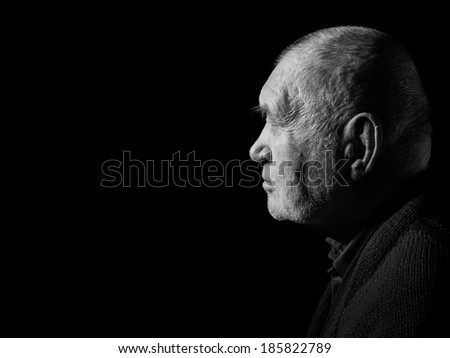 sad elderly gray man senior in dark