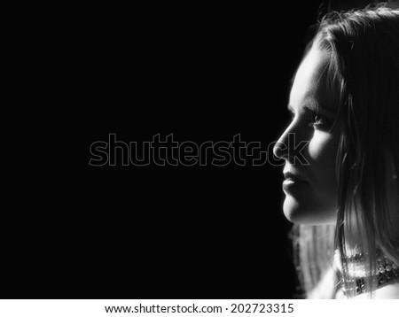 profile of young sensual woman on black background monochrome image