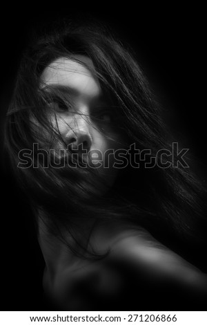 bared woman with fluffy hair looking back monochrome