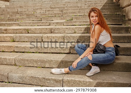Portrait of a smiling woman sitting on steps