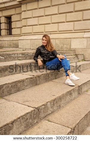 Portrait of a happy woman sitting on steps