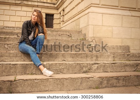 Portrait of a serious woman sitting on steps