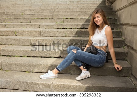Portrait of a smiling woman sitting on steps