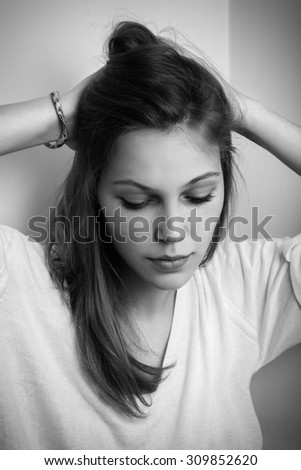 pensive sad young woman with long hairs monochrome