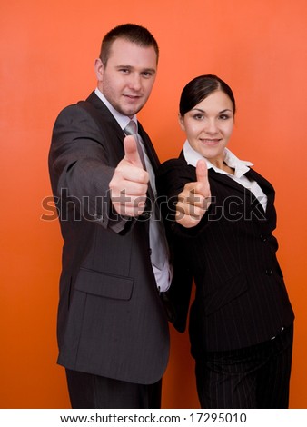 woman and man in team standing on orange background