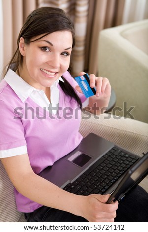 young adult brunette woman with laptop and credit card