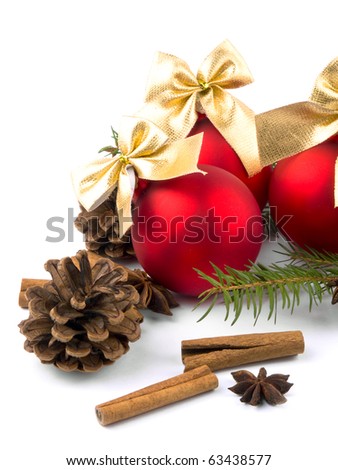 Red glass balls with nice golden ribbons, cinnamon and fresh spruce on white background