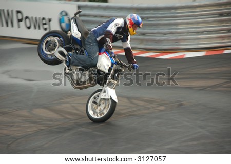 biker perform a demo in full protection gear and wheelly
